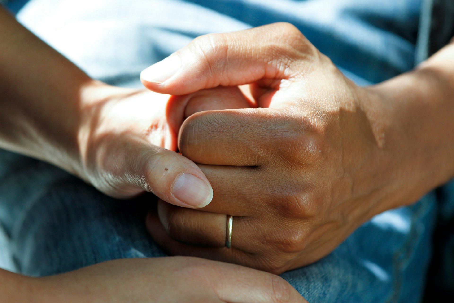 image of caregiver holding hands with patient to demonstrate the power of relationships in in-home dental care